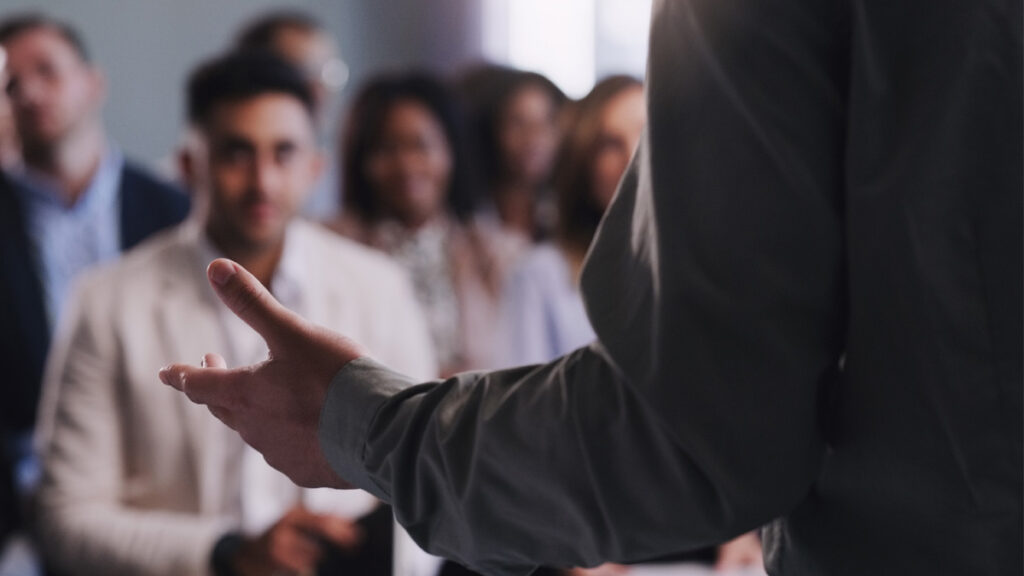 Closeup shot of an unrecognisable businessman delivering a presentation during a conference