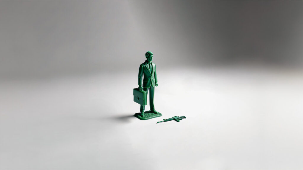 A toy figure of a businessman with a briefcase, dressed in a smart suit, in the style of a little green army soldier