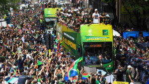 South Africa's team celebrates from a bus with supporters during the Springboks Champions trophy tour in Cape Town on November 3, 2023