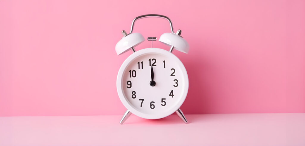 A clock on a pink background