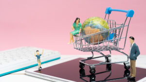 Figurines of a man, woman, child and shopping trolley on a tablet