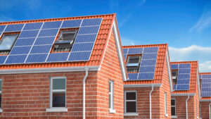 Row of house with solar panels on roof on blue sky background