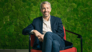 Josh Bayliss CEO Virgin Group sitting on a chair
